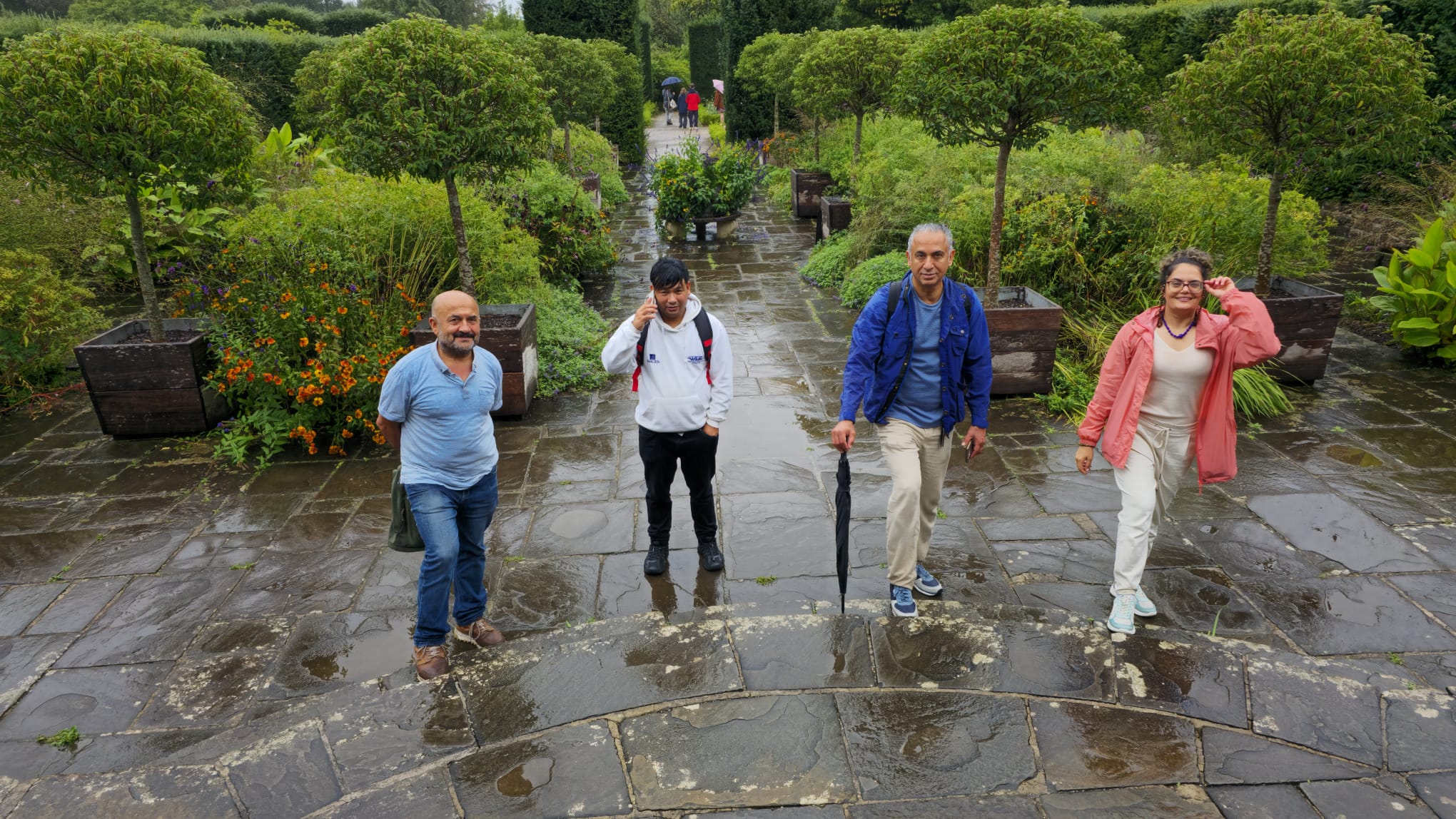 A group walking through a landscaped historic garden